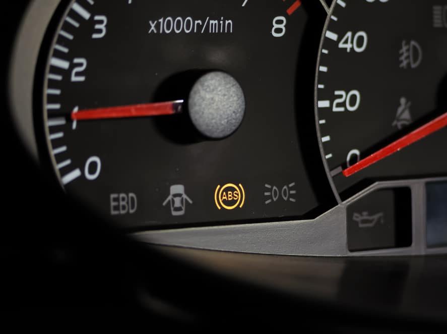 ABS warning light illuminated on a car instrument panel